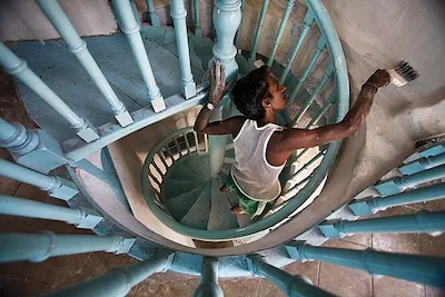 Jorge Royan Painting showing a man painting a spiral staircase from within